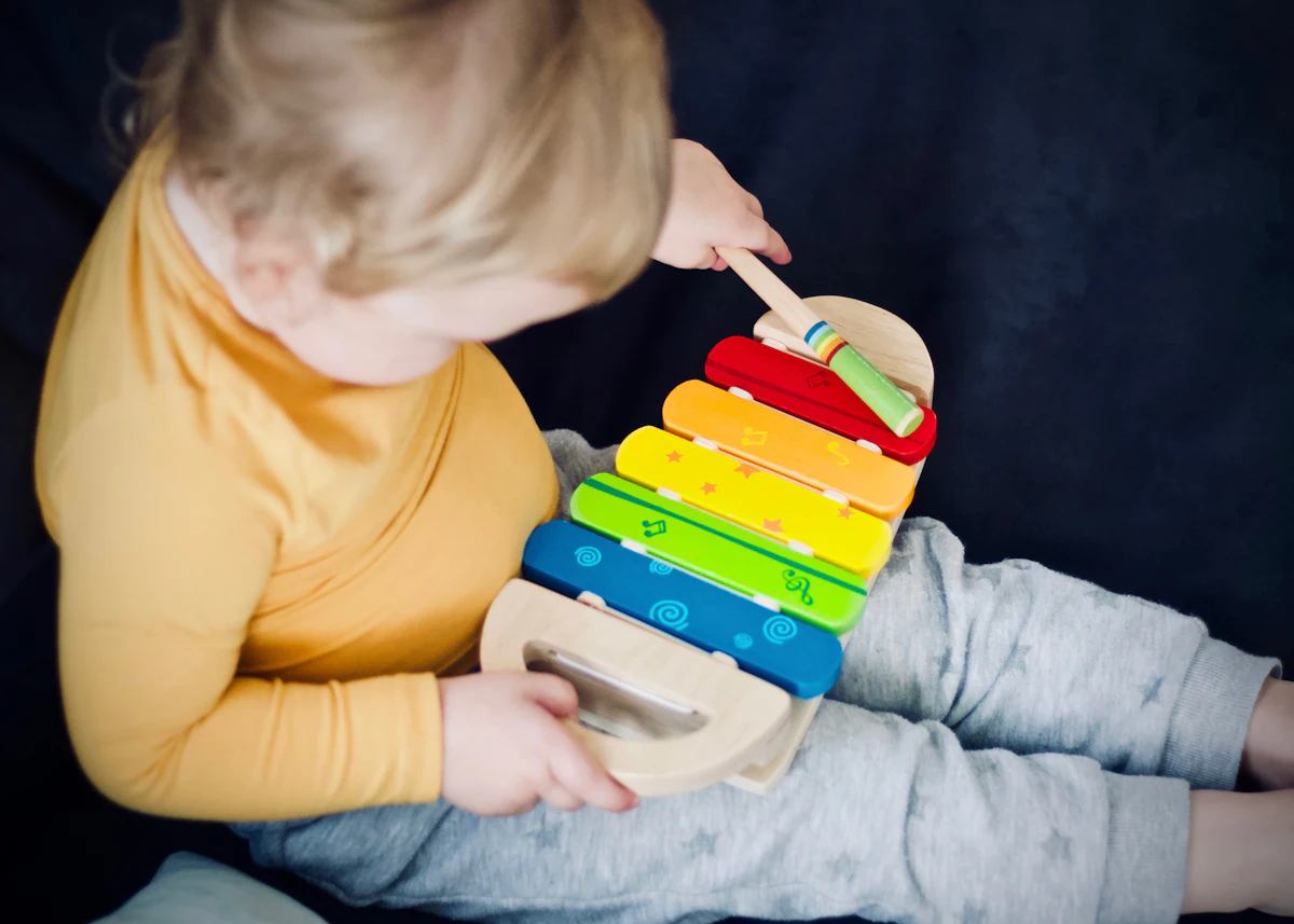 Un tout-petit joue d'un xylophone arc-en-ciel